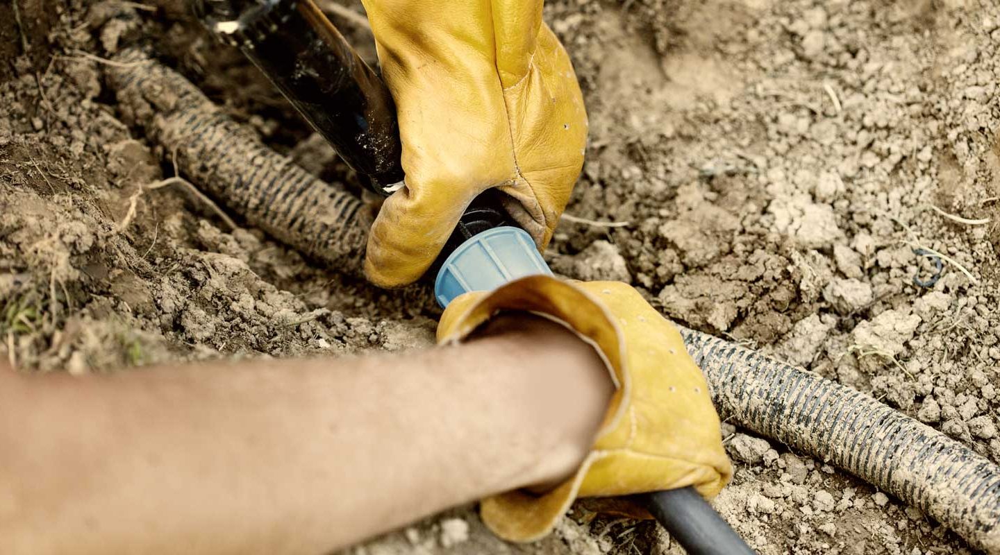 a man connecting a pipe to a joint
