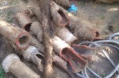 a collection of old and broken concrete water pipes