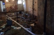 water pipes being laid in an unfinished basement