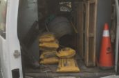 the back of a white van filled with construction equipment