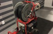 a red machine with a hose on top of it