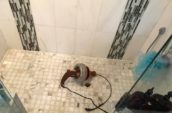 plumbing equipment on the floor of a shower