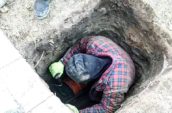a man with a hat is in a hole