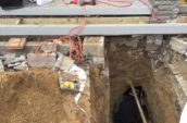 a hole in the side of a house that is under construction