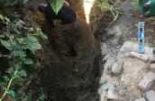 a man digging a hole in the ground