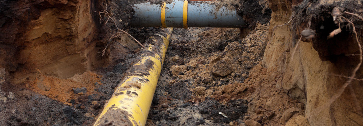 a trench with two water pipes at right angles to each other