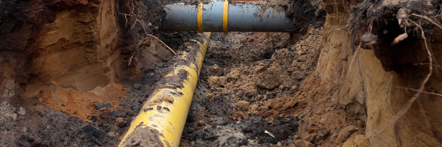 a trench with two water pipes at right angles to each other