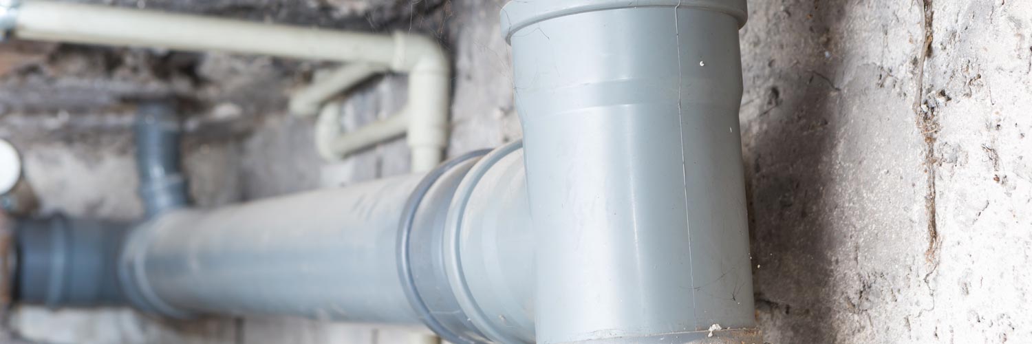 water pipes running along a wall