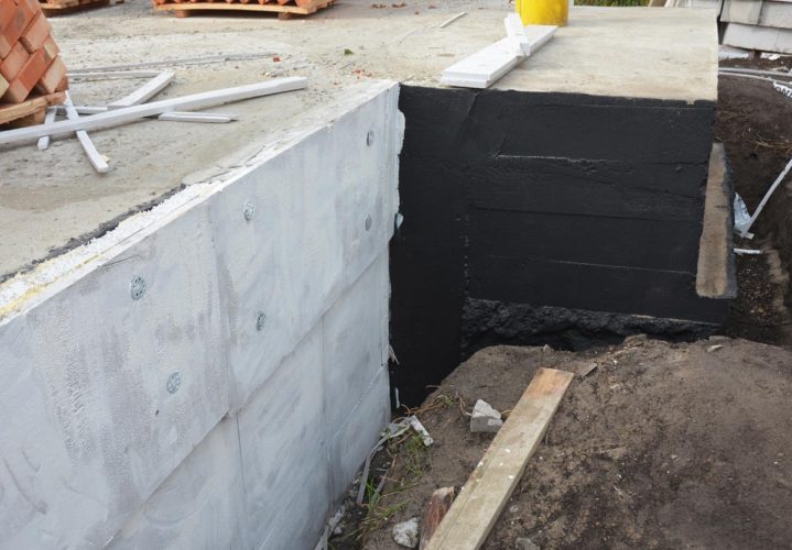 a building under construction with a hole in the ground