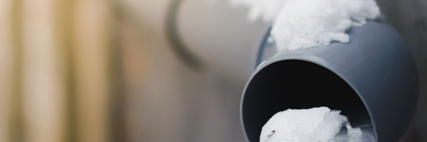 an outflow pipe partially covered with snow