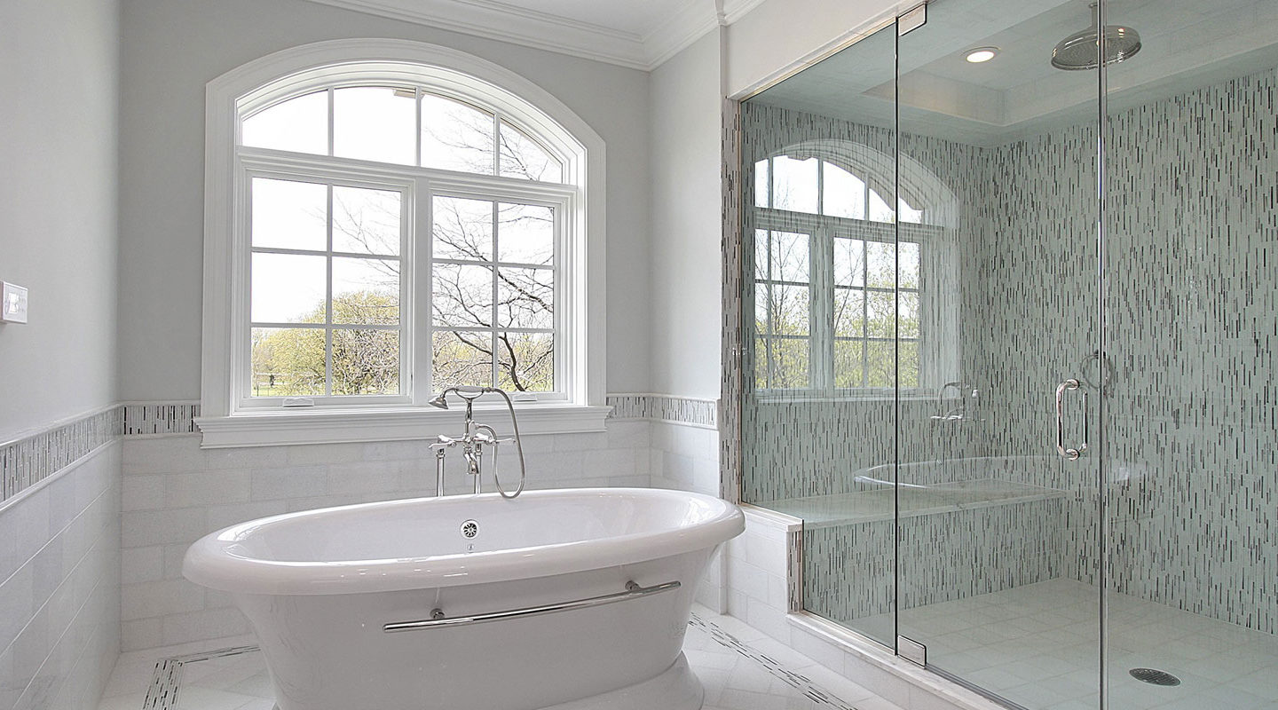 a white bath tub sitting next to a window